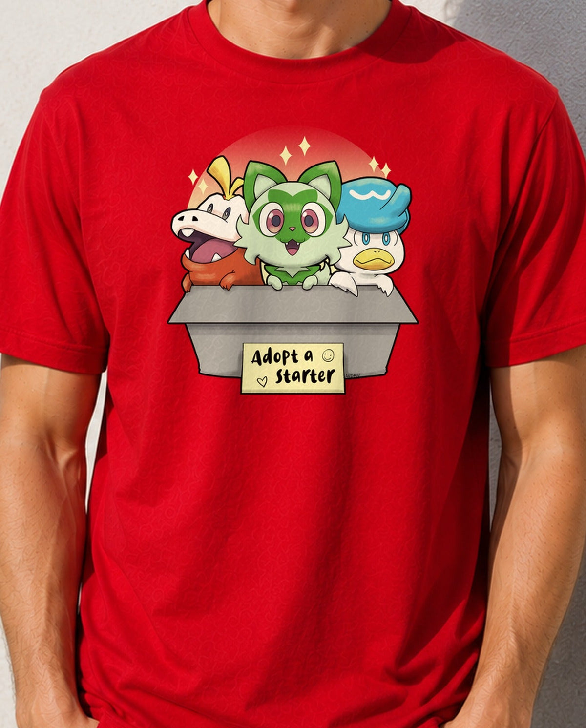 Camiseta Adopt a Starter – Criaturas para Adoptar (roja)